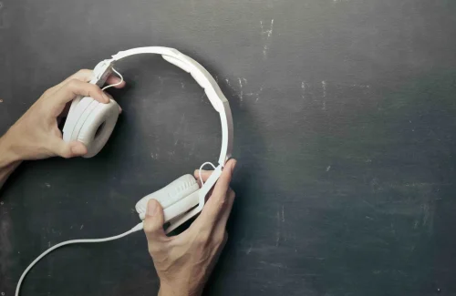 hands holding headphones