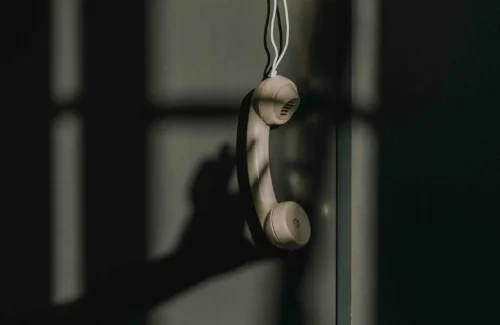 phone with a cord hanging in the air