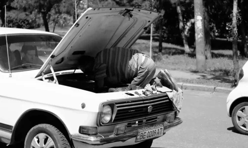 man fixing a car