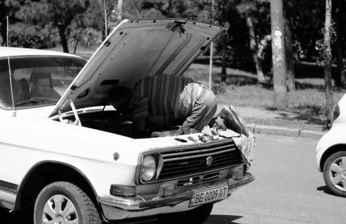 man fixing a car