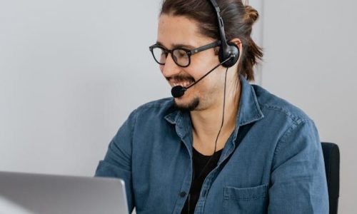 A person is using a headset to make a customer service call.