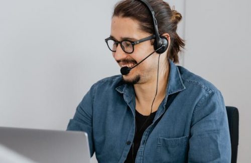 A person is using a headset to make a customer service call.