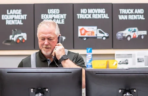 Man having a phone call in the equipment rental store