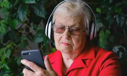 elderly woman using interactive voice response technology
