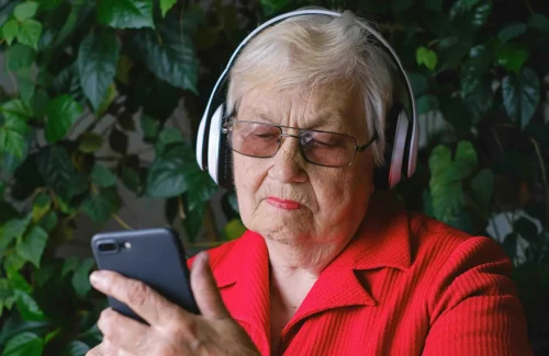 elderly woman using interactive voice response technology