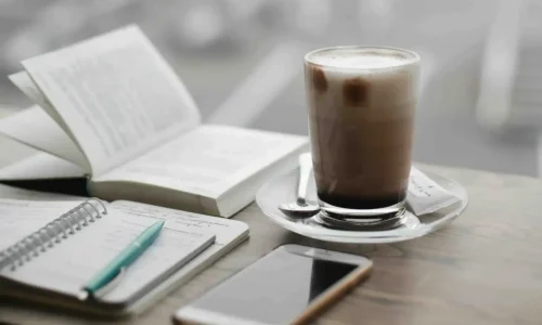 notebooks, phone and coffee on the table - content planning