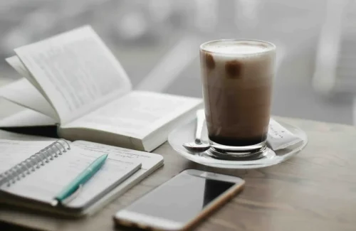 notebooks, phone and coffee on the table - content planning