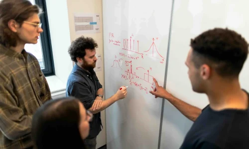 three coworkers analyzing data on the table