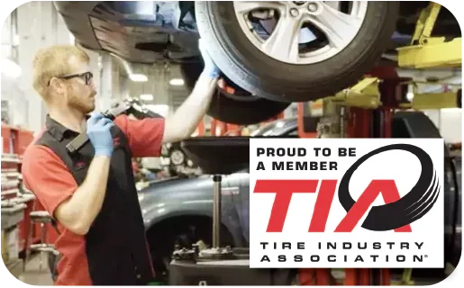 Man working in an automotive shop, focusing on tire repair.