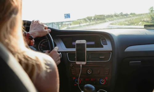 A woman driving with car phone holder