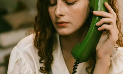 Woman on the Phone Talking to another Person