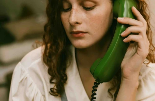 Woman on the Phone Talking to another Person